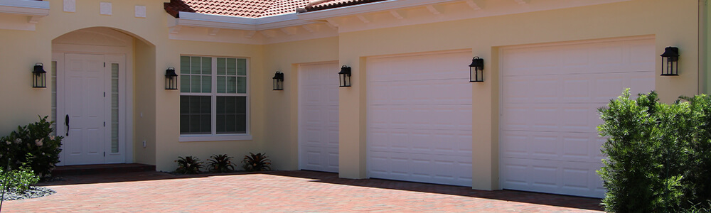 Tan House with White Garage Doors